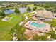 Aerial of community pool, tennis courts, clubhouse and lake nearby at 11333 Camden Park Dr, Windermere, FL 34786