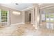 Elegant dining room with stone flooring, decorative lighting, and ample space for entertaining at 11333 Camden Park Dr, Windermere, FL 34786