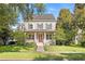 Charming two-story home featuring a inviting front porch, well-manicured lawn and mature trees at 11333 Camden Park Dr, Windermere, FL 34786