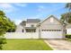 Beautiful home exterior with a lush green lawn, white fence, and attached garage at 11333 Camden Park Dr, Windermere, FL 34786