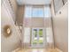 Grand foyer with soaring ceilings, decorative mirror and staircase at 11333 Camden Park Dr, Windermere, FL 34786