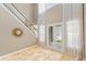 Inviting foyer features travertine floors, staircase, and French doors to the outdoor space at 11333 Camden Park Dr, Windermere, FL 34786
