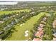Aerial shot of a golf course surrounded by trees and residential homes at 11333 Camden Park Dr, Windermere, FL 34786