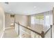Upstairs hallway with natural light and neutral carpet at 11333 Camden Park Dr, Windermere, FL 34786