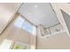 Bright interior showcasing high ceilings, staircase and tall windows with elegant sheer curtains at 11333 Camden Park Dr, Windermere, FL 34786