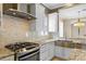A gourmet kitchen features stainless steel appliances, granite counters, and a designer tile backsplash at 11333 Camden Park Dr, Windermere, FL 34786