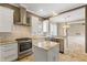 The gourmet kitchen features stainless steel appliances and an island overlooking the living room at 11333 Camden Park Dr, Windermere, FL 34786