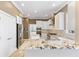 The expansive kitchen features granite countertops, stainless appliances, and stylish white cabinets at 11333 Camden Park Dr, Windermere, FL 34786