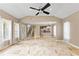 Spacious living room with marble floors, ceiling fan, and access to kitchen and second story at 11333 Camden Park Dr, Windermere, FL 34786