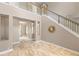 Open living room featuring stone flooring, neutral walls, and staircase at 11333 Camden Park Dr, Windermere, FL 34786
