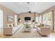 The open-concept living room includes contemporary furnishings, high ceilings, and lots of natural light at 11333 Camden Park Dr, Windermere, FL 34786