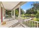 Inviting covered front porch with white columns offering a picturesque view of the neighborhood at 11333 Camden Park Dr, Windermere, FL 34786