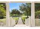 Scenic view from the covered front porch showcasing the lush greenery and serene pond at 11333 Camden Park Dr, Windermere, FL 34786