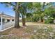 View of the home's backyard, highlighting the mature trees, and partial view of the house at 116 Morning Glory Dr, Lake Mary, FL 32746