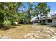 View of the house from the backyard, featuring the screened-in porch at 116 Morning Glory Dr, Lake Mary, FL 32746