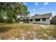 Exterior view of the home's backyard, featuring mature trees at 116 Morning Glory Dr, Lake Mary, FL 32746