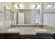 Bathroom featuring double sinks, granite countertop and large mirror at 116 Morning Glory Dr, Lake Mary, FL 32746