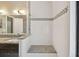 Tiled bathroom with tiled shower, granite counter, double sinks, and a large mirror at 116 Morning Glory Dr, Lake Mary, FL 32746