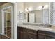 Bright bathroom features double sinks, granite counters, and a tiled shower at 116 Morning Glory Dr, Lake Mary, FL 32746