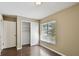 Cozy bedroom featuring wood-look floors, a closet with sliding doors, and a window at 116 Morning Glory Dr, Lake Mary, FL 32746