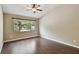 Spacious bedroom features large window and hardwood floors with ceiling fan at 116 Morning Glory Dr, Lake Mary, FL 32746