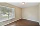 Bedroom with hardwood floors, tan walls, and a large window with blinds at 116 Morning Glory Dr, Lake Mary, FL 32746