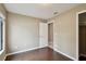 Bedroom with hardwood floors, and tan walls, closet with mirrored doors at 116 Morning Glory Dr, Lake Mary, FL 32746