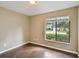 Bedroom with hardwood floors, tan walls, and a large window at 116 Morning Glory Dr, Lake Mary, FL 32746