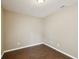 Bedroom with modern light fixture, neutral walls, and dark wood-look flooring at 116 Morning Glory Dr, Lake Mary, FL 32746