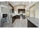 Modern kitchen with stainless steel appliances, granite countertops, and tiled flooring creating an elegant space at 116 Morning Glory Dr, Lake Mary, FL 32746