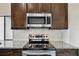Modern kitchen features stainless steel appliances, granite countertops and stylish backsplash at 116 Morning Glory Dr, Lake Mary, FL 32746