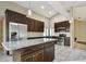 Open-concept kitchen with stainless steel appliances, granite countertops, and a spacious island for food preparation at 116 Morning Glory Dr, Lake Mary, FL 32746