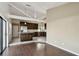 Open living area with hardwood floors leading into kitchen with stainless steel appliances at 116 Morning Glory Dr, Lake Mary, FL 32746