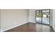 View of the covered patio from a living area with glass sliding doors and hardwood flooring at 116 Morning Glory Dr, Lake Mary, FL 32746