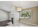 Open living space with a fireplace, dining area, and a large window providing natural light and a view of the greenery at 116 Morning Glory Dr, Lake Mary, FL 32746