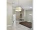 Spacious living space with tiled floors, modern lighting fixtures, and a view of the home's entrance at 116 Morning Glory Dr, Lake Mary, FL 32746