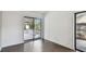 View of the covered patio from a living area with glass sliding doors and hardwood flooring at 116 Morning Glory Dr, Lake Mary, FL 32746