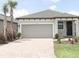 Beautiful single-Gathering home boasts a brick paved driveway and a neutral gray exterior at 1328 Lombardi Ct, Poinciana, FL 34759