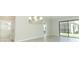 Open-concept living area featuring tile flooring, modern light fixtures, and access to the backyard at 1328 Lombardi Ct, Poinciana, FL 34759