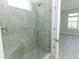 Modern tiled shower with a glass door and a built-in bench at 1328 Lombardi Ct, Poinciana, FL 34759