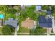 Aerial view of the home, its roof, well-maintained yard, mature trees, and neighborhood at 1328 S Oxalis Ave, Orlando, FL 32807