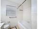 Bathroom showcasing white tile, classic fixtures and a tub with shower at 1328 S Oxalis Ave, Orlando, FL 32807