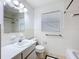 Bathroom with white tile, a window for natural light, and classic fixtures and finishes at 1328 S Oxalis Ave, Orlando, FL 32807