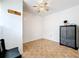 Simple bedroom featuring tile floors, ceiling fan, and closet space for efficient storage and comfort at 1328 S Oxalis Ave, Orlando, FL 32807