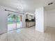 Open dining area featuring sliding glass doors to the backyard and a chandelier, blending indoor/outdoor living at 1328 S Oxalis Ave, Orlando, FL 32807