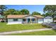 Charming single-story home featuring a well-maintained lawn, and a quaint front porch with blue accents at 1328 S Oxalis Ave, Orlando, FL 32807