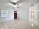 Bright and airy living room with neutral tile flooring and a ceiling fan, offering a comfortable and clean space at 1328 S Oxalis Ave, Orlando, FL 32807