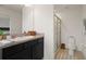 Bright bathroom features a vanity with cabinets, a sink, and a large framed mirror at 141 Claire Ln, Davenport, FL 33837