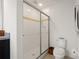 Bright bathroom featuring a glass-enclosed shower, white tile and modern fixtures at 141 Claire Ln, Davenport, FL 33837