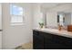 Bright bathroom features a vanity with cabinets, a sink, and a window for natural light at 141 Claire Ln, Davenport, FL 33837